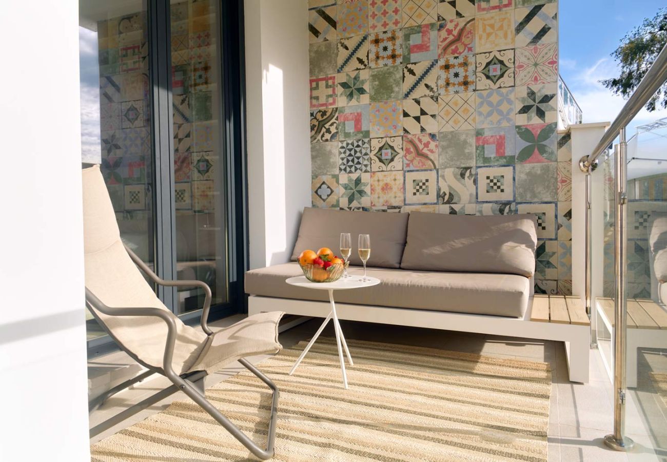 Outdoor lounge area with sofa on private seafront terrace in Balcón del Mar.