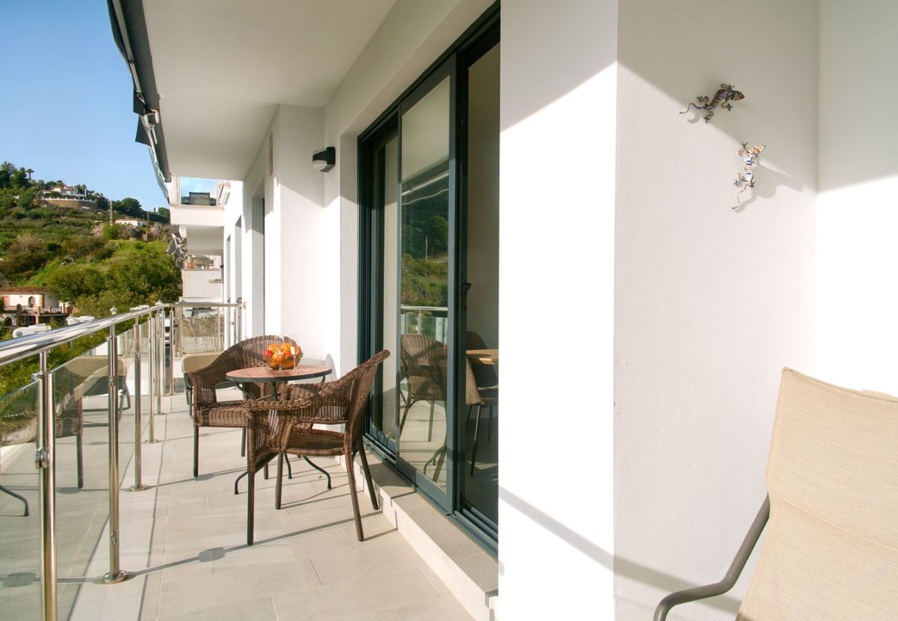 Private terrace with sea views in Nerja featuring outdoor furniture and afternoon sun.