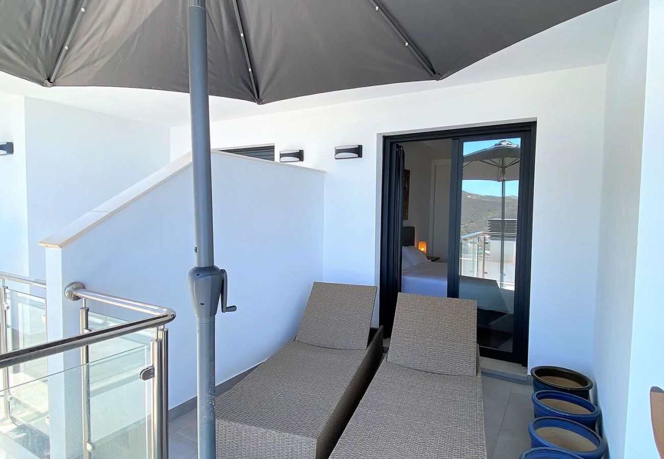 Private sun deck with loungers and sea views at apartment 216.
