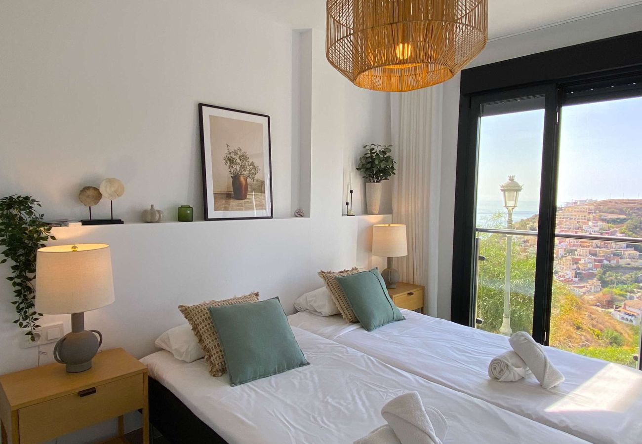 Stylish double bedroom with mountain views in a Nerja holiday rental.
