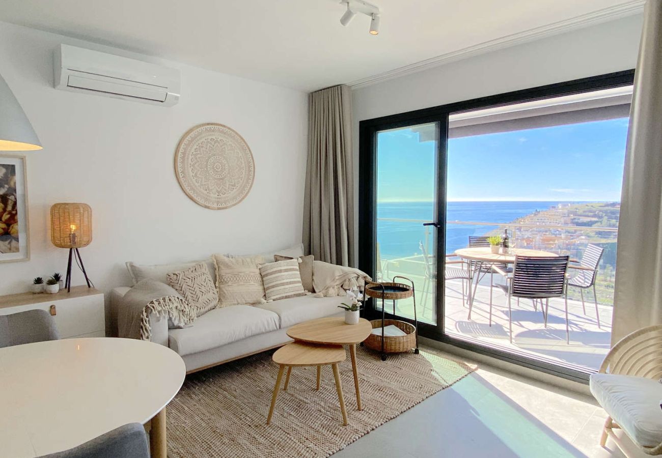 Modern living room with direct terrace access and sea views in Balcon del Mar Nerja.