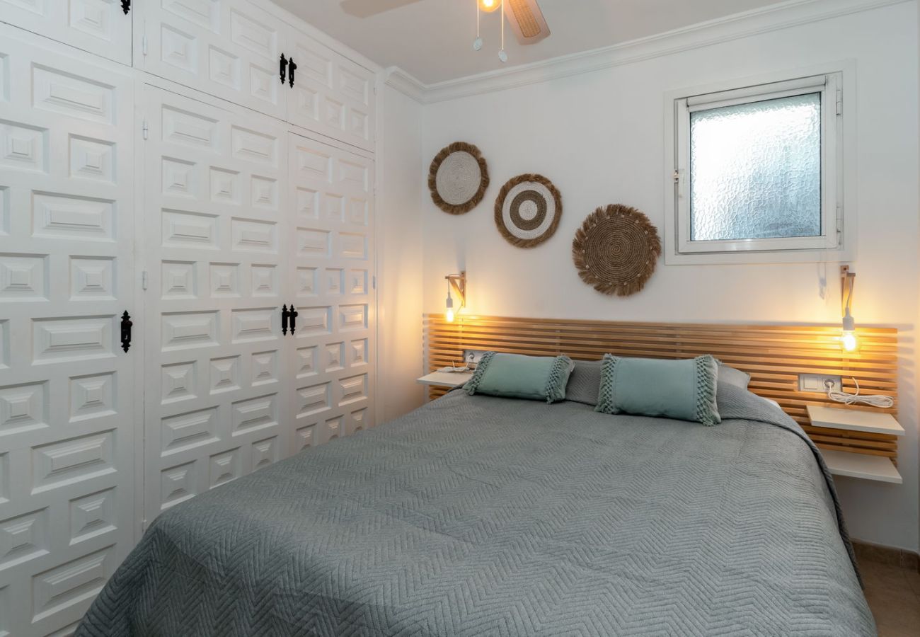 Cosy master bedroom with double bed and warm atmosphere, ideal for couples in Nerja.