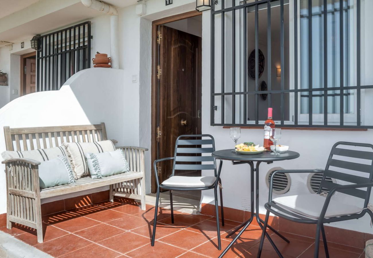 South-facing private terrace with outdoor furniture and Mediterranean views on the beachfront of Nerja.