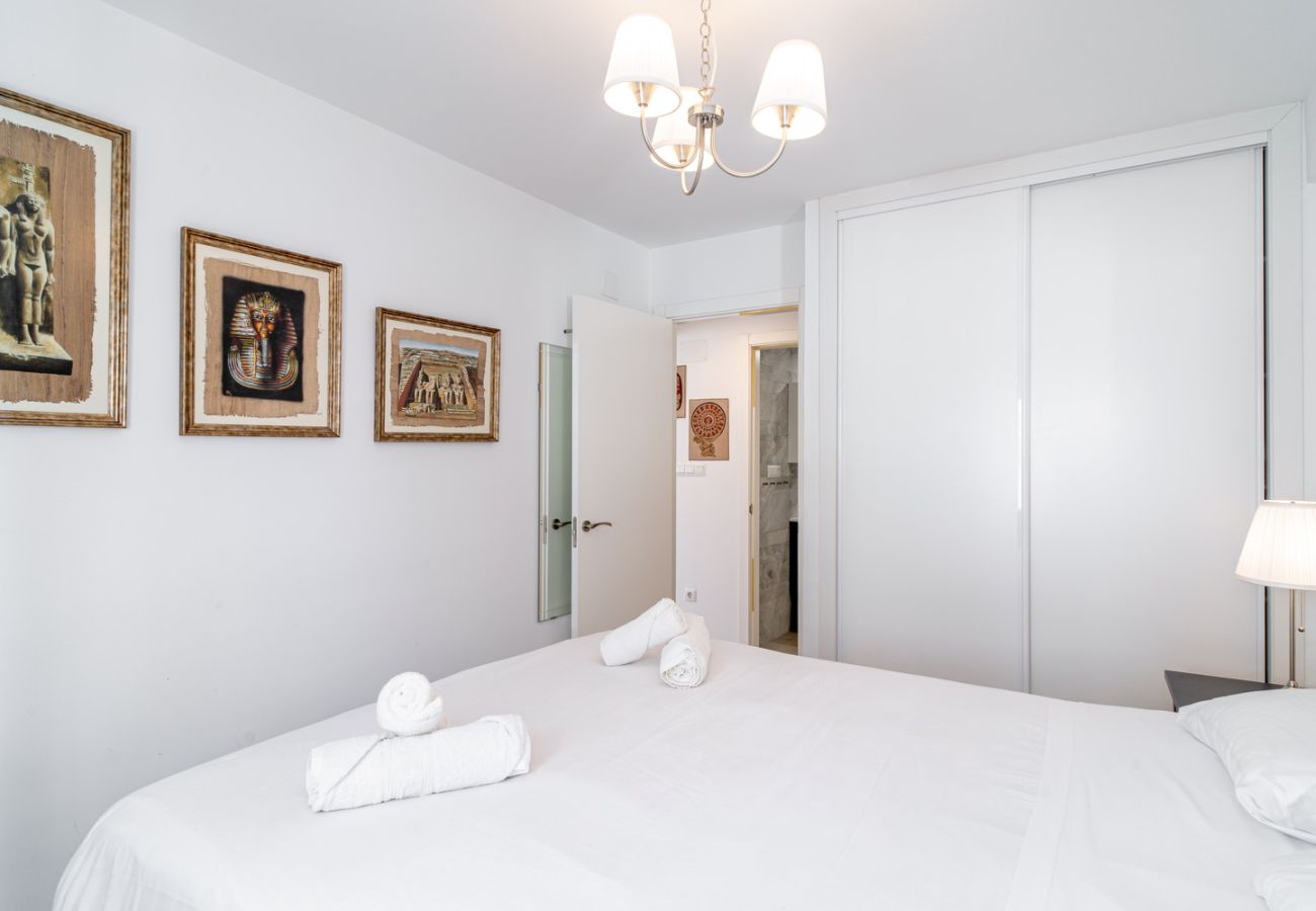 Master bedroom with double bed and elegant decor in Urban Suite Apartment.