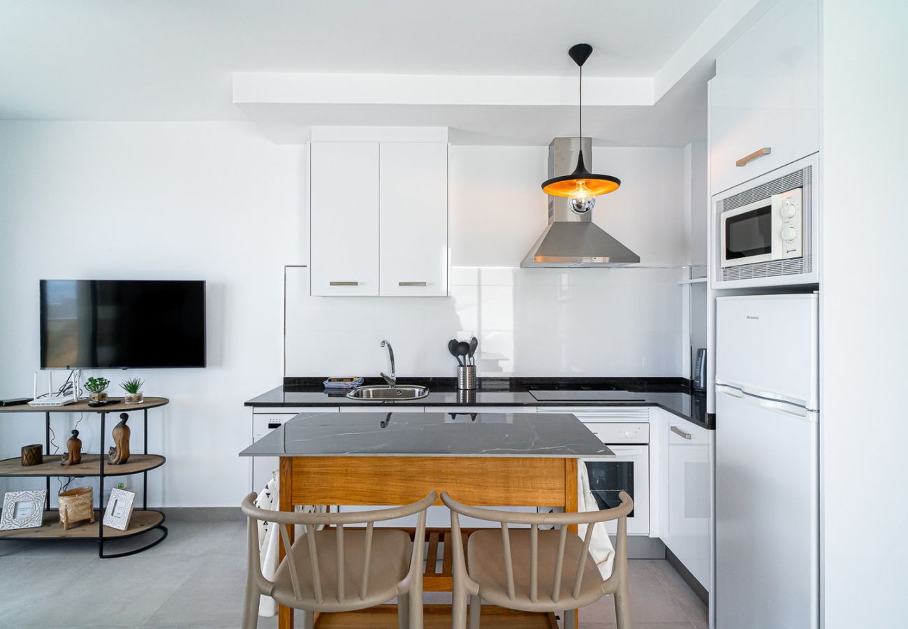 Modern designer kitchen fully equipped with high-end appliances and open-plan layout in Nerja.
