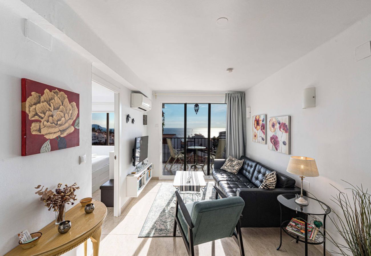 Living room with sofa and TV in apartment in Nerja