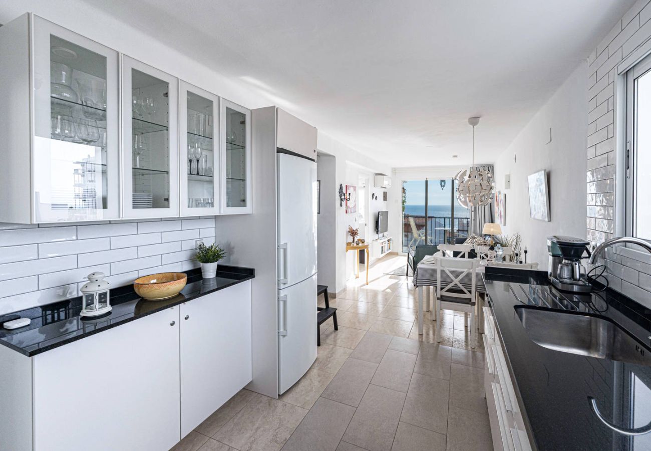 Kitchen with full tableware in holiday accommodation in Nerja