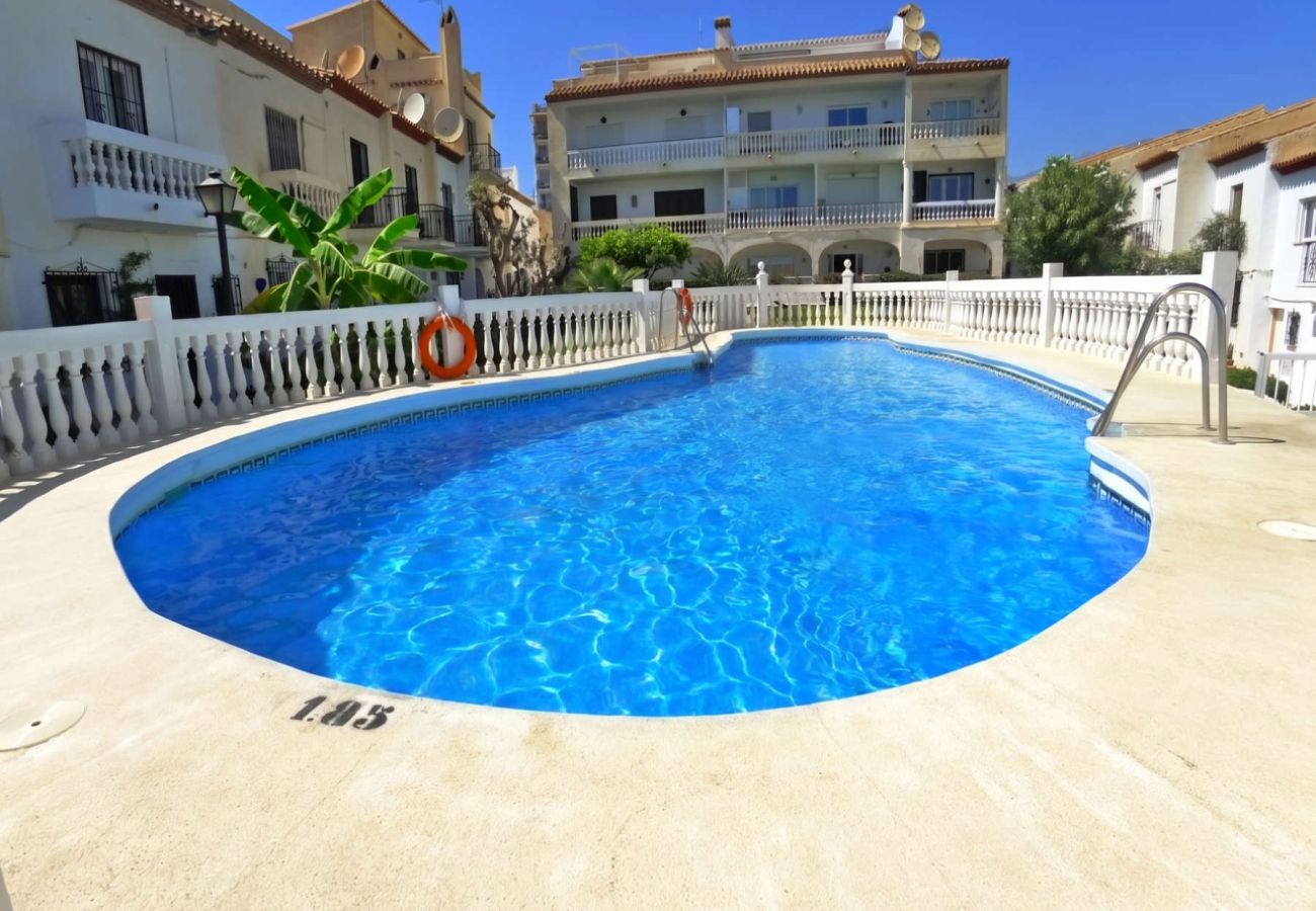 Communal swimming pool surrounded by gardens in La Hacienda urbanisation, Nerja.