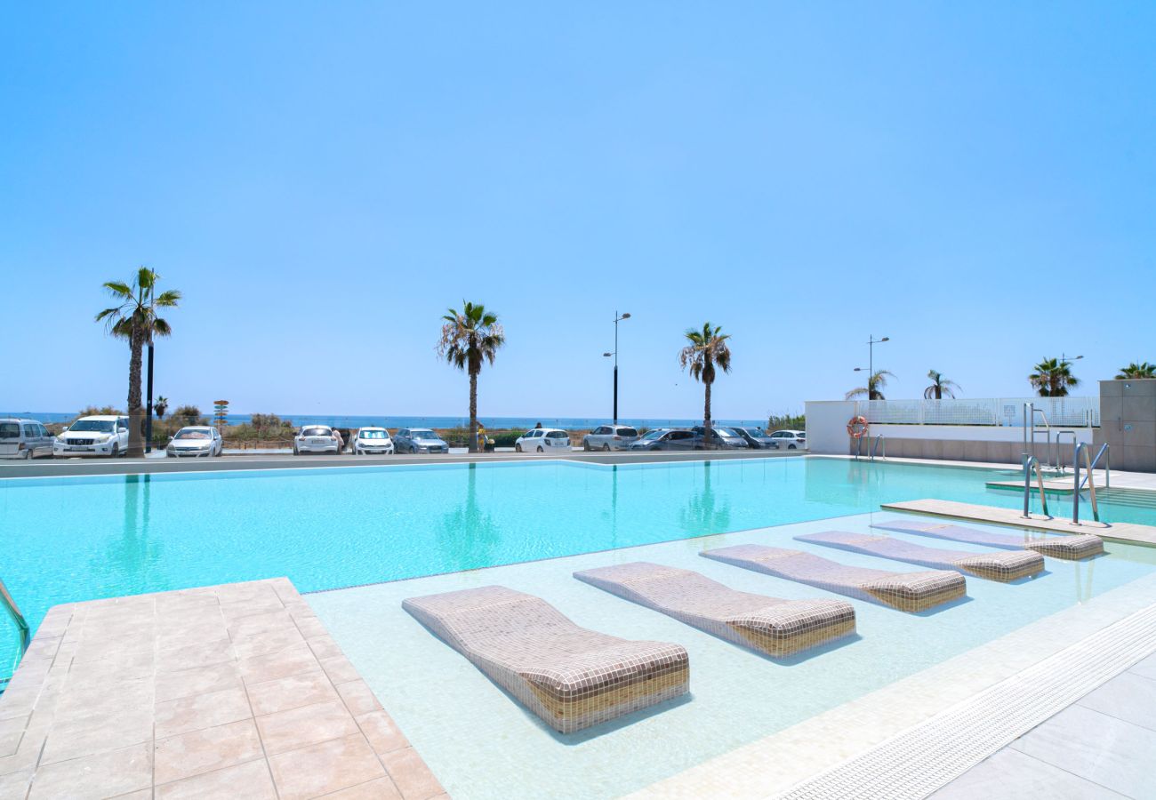 Communal infinity pool and Las Dunas Beach in Torrox Costa.